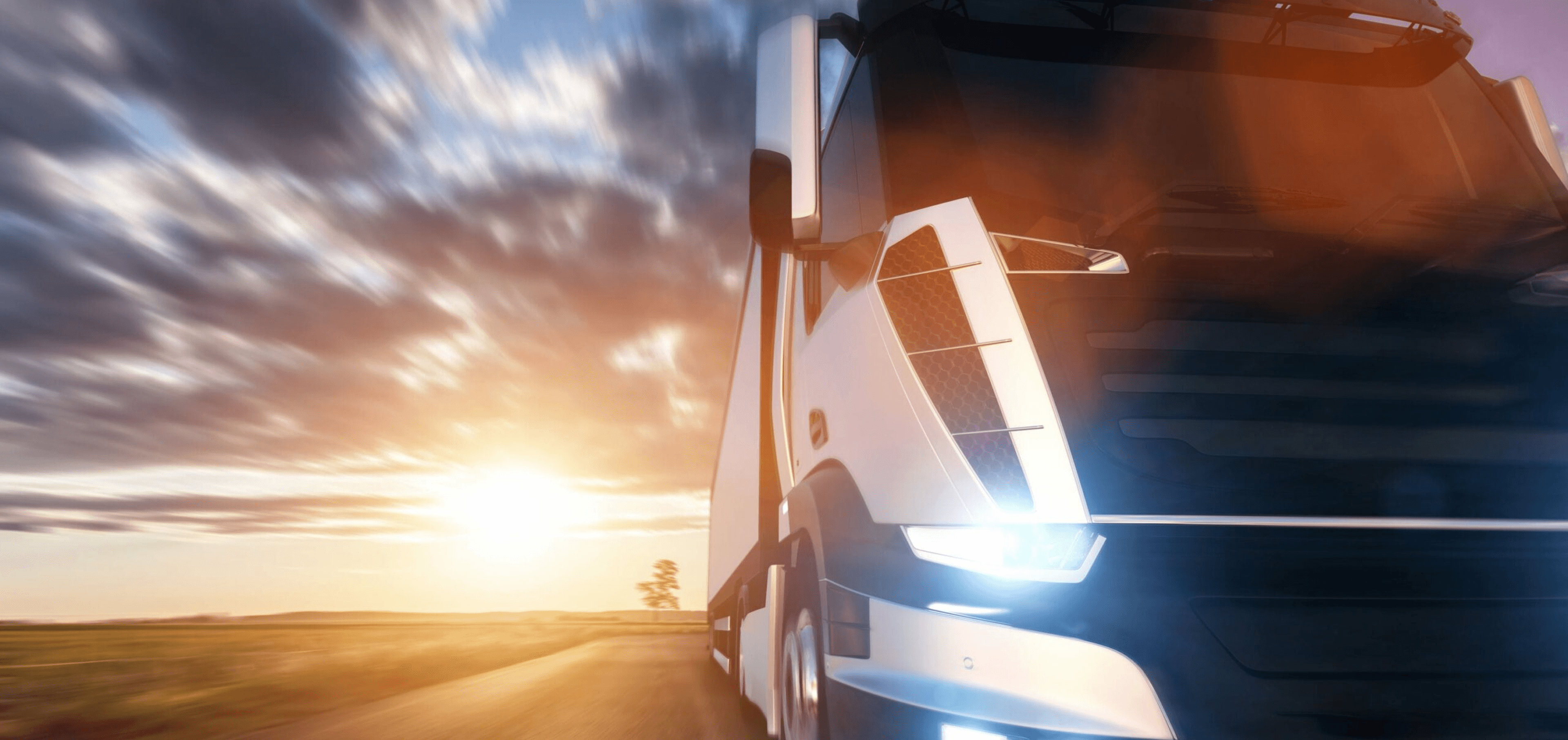 Electric vehicles on a road at sunset